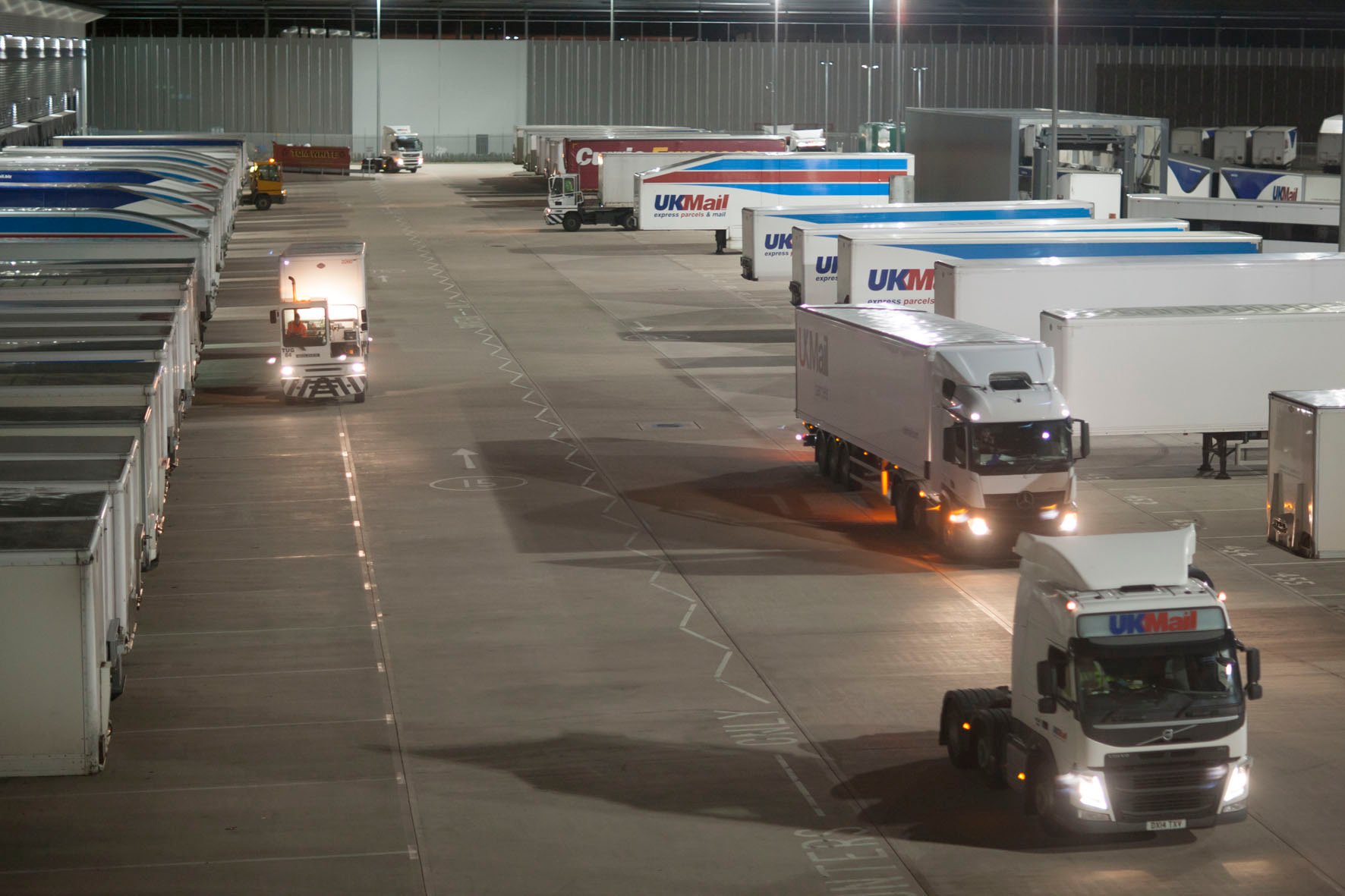 Delivery trucks at a UK Mail hub